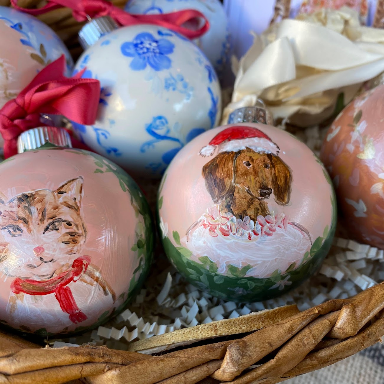 A custom handpainted christmas ornaments of pets with wallpaper backgrounds and portraits of pets with holiday themed attire. 